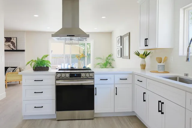 a kitchen with white cabinets and white appliances