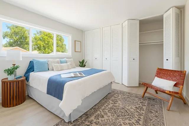 a bathroom with a granite countertop toilet and a shower