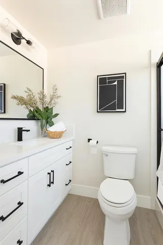 a white toilet sitting next to a bathroom sink