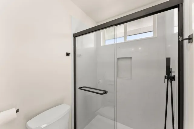 a view of an empty room and wooden floor