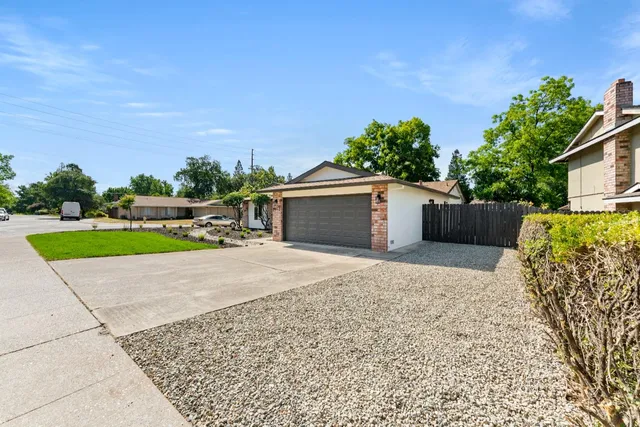 front view of a house with a yard and a garage