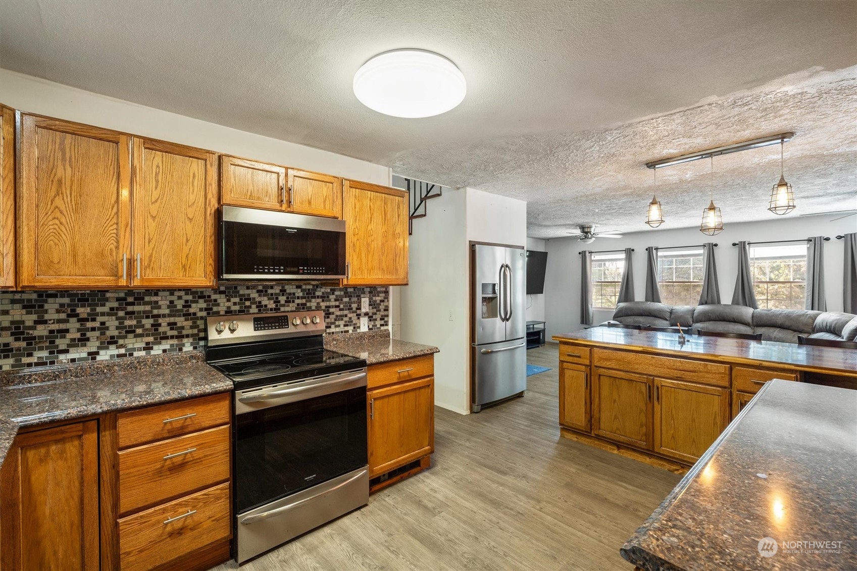 3827 Sunset Way Longview, WA 98632 - Photo 15 of 40 a kitchen with stainless steel appliances a stove sink and cabinets