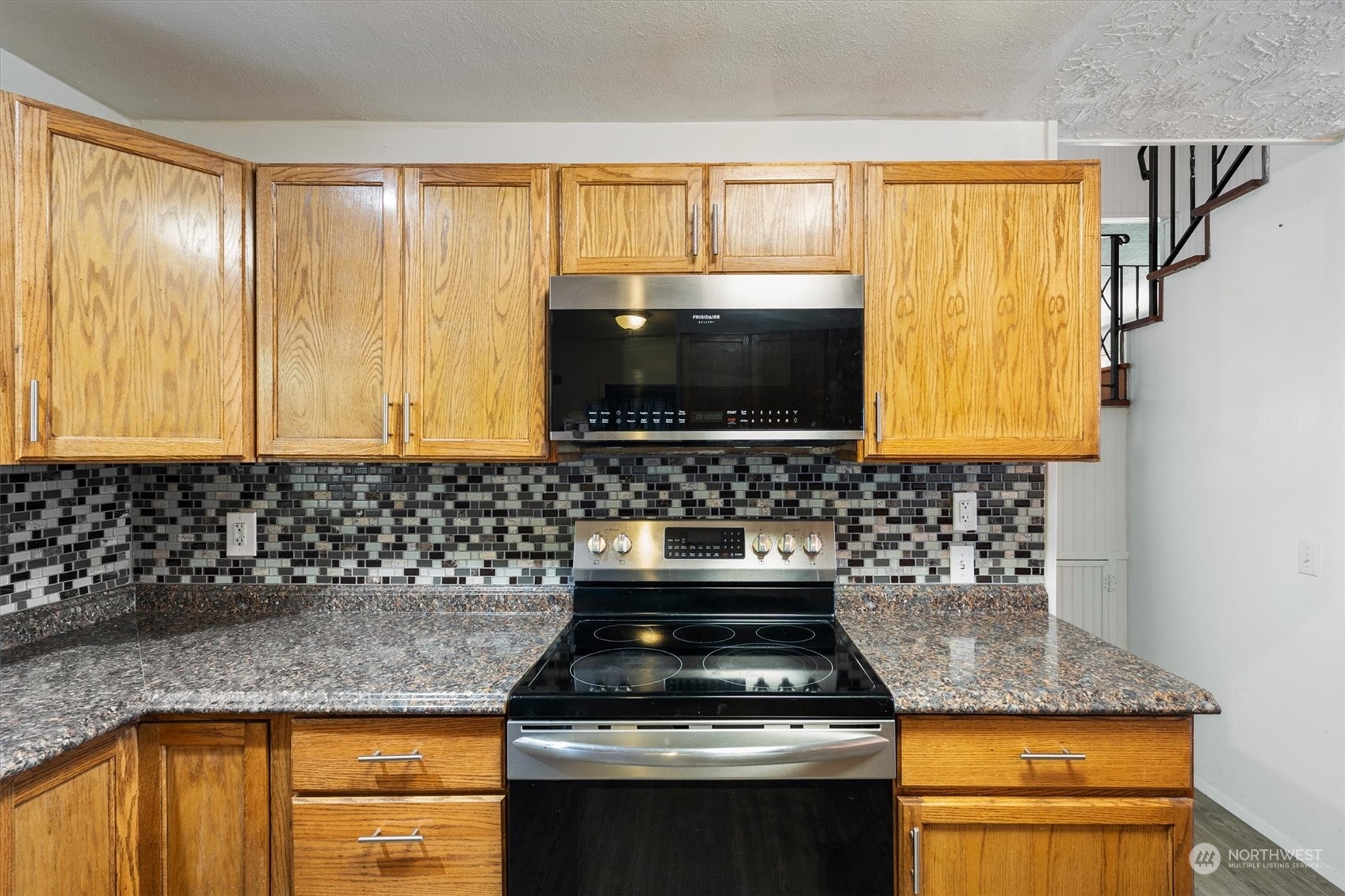 3827 Sunset Way Longview, WA 98632 - Photo 17 of 40 a kitchen with granite countertop a sink and a stove top oven