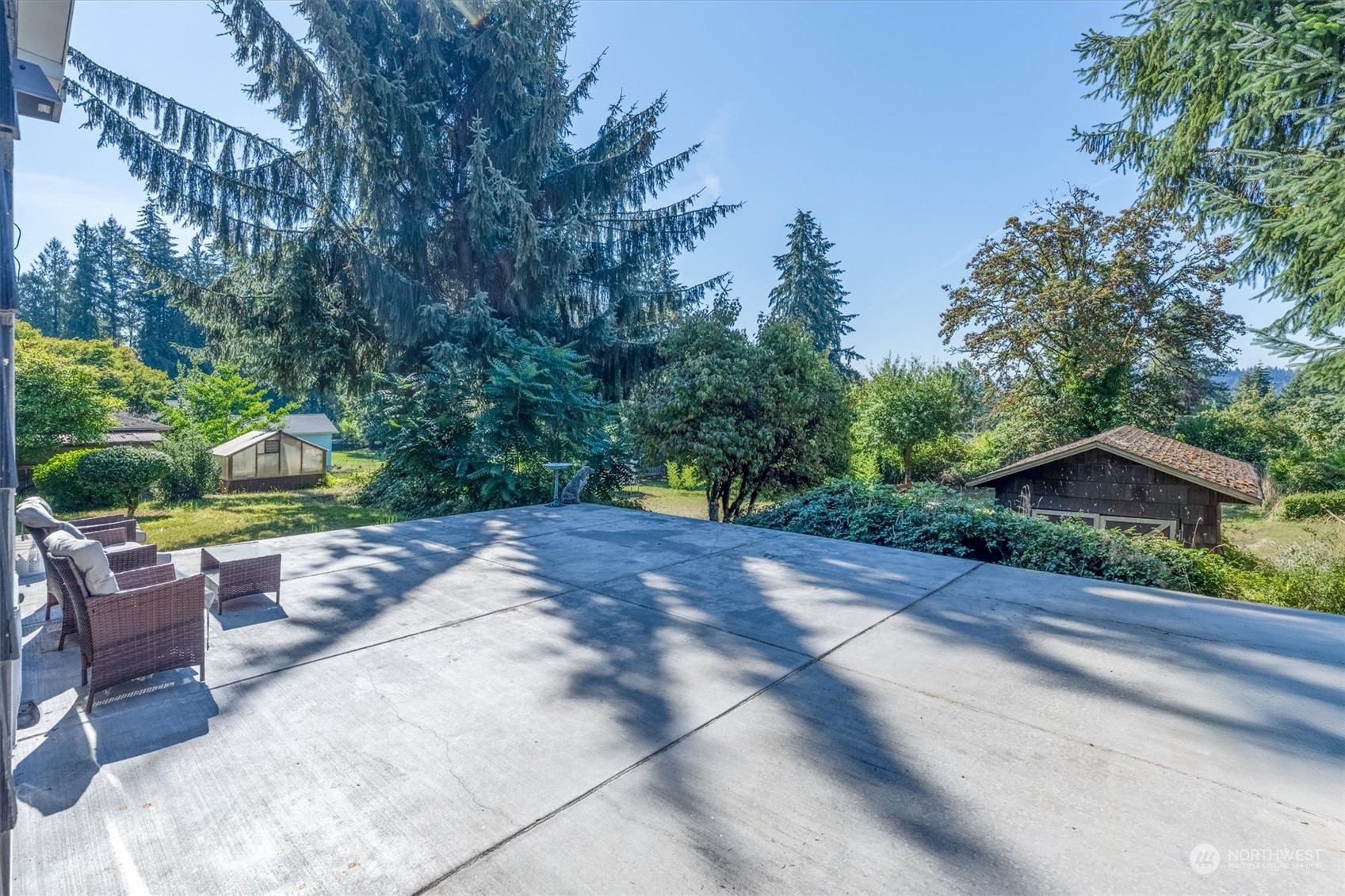 3827 Sunset Way Longview, WA 98632 - Photo 36 of 40 a view of a backyard with potted plants and a large tree