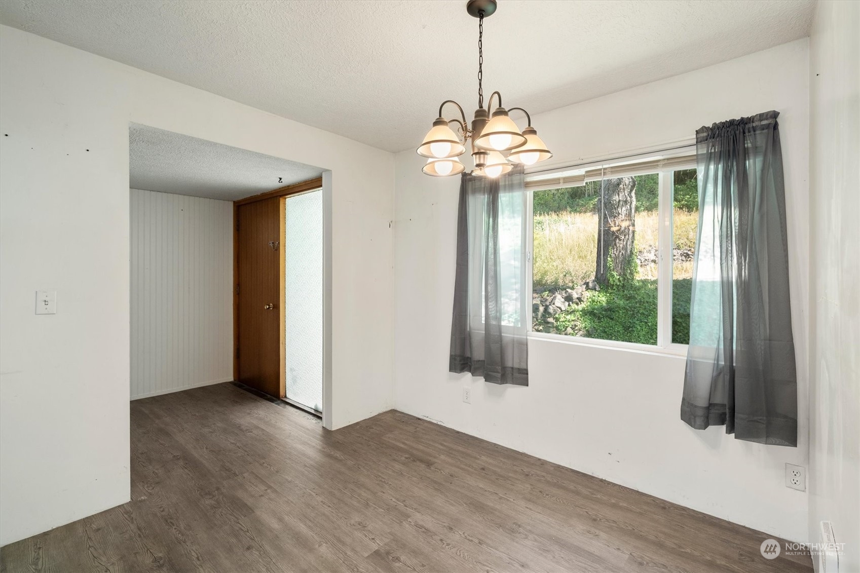 3827 Sunset Way Longview, WA 98632 - Photo 6 of 40 a view of a livingroom with a chandelier wooden floor and a chandelier