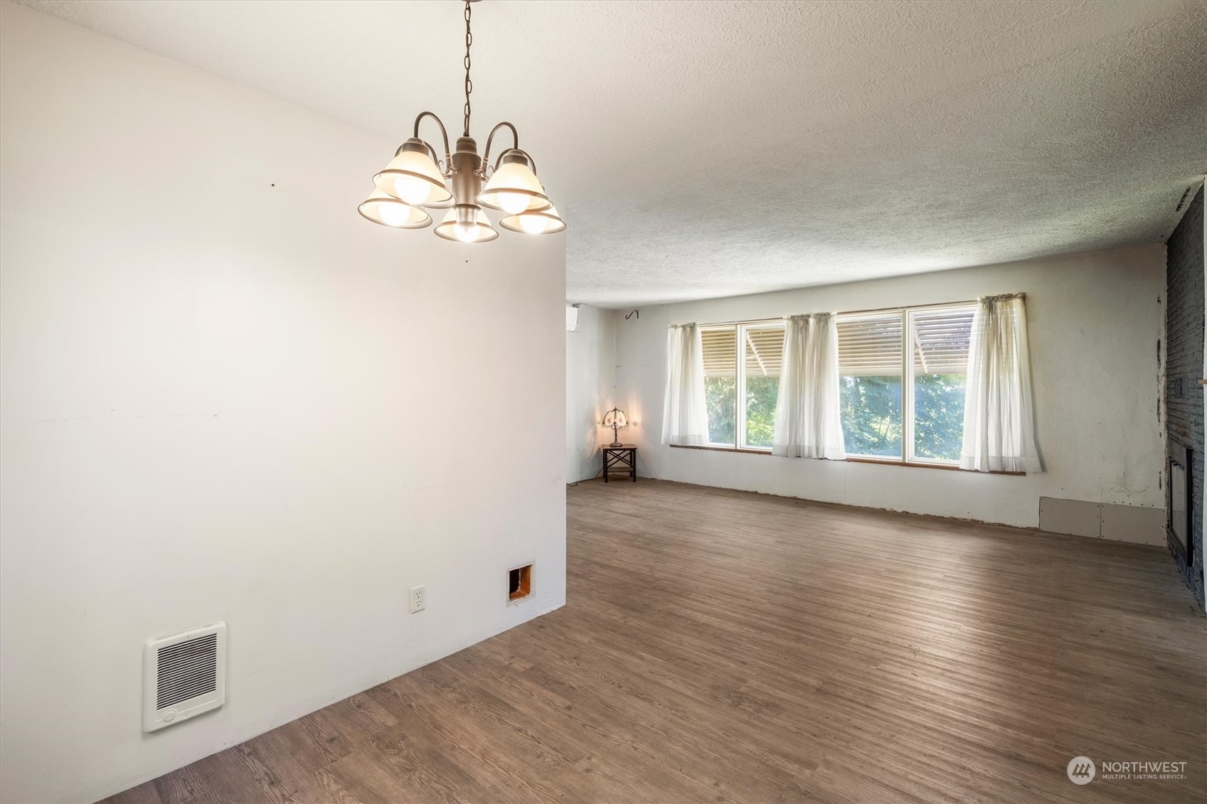 3827 Sunset Way Longview, WA 98632 - Photo 7 of 40 an empty room with wooden floor and windows