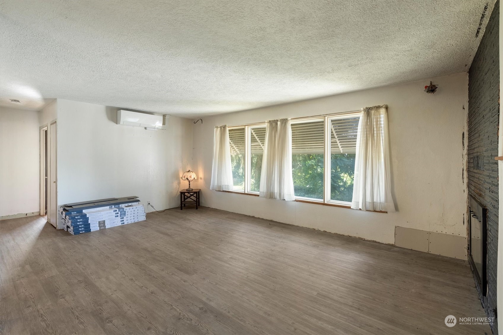 3827 Sunset Way Longview, WA 98632 - Photo 9 of 40 an empty room with wooden floor and windows