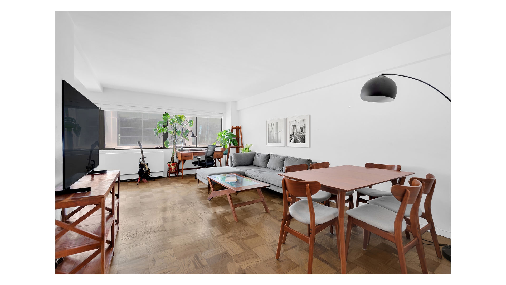 310 West 56th Street, Unit 10F Manhattan, NY 10019 - Photo 1 of 6 a living room with furniture and a large window
