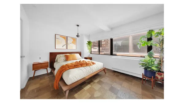 a kitchen with cabinets and wooden floor