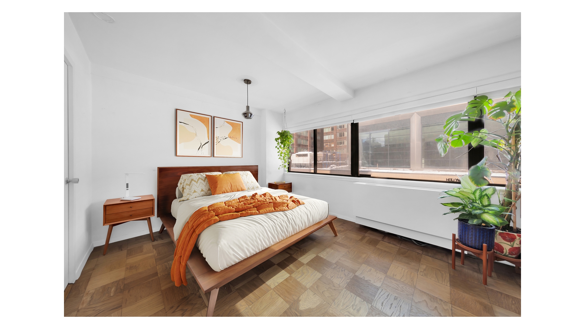 310 West 56th Street, Unit 10F Manhattan, NY 10019 - Photo 4 of 6 a bedroom with a bed and a potted plant