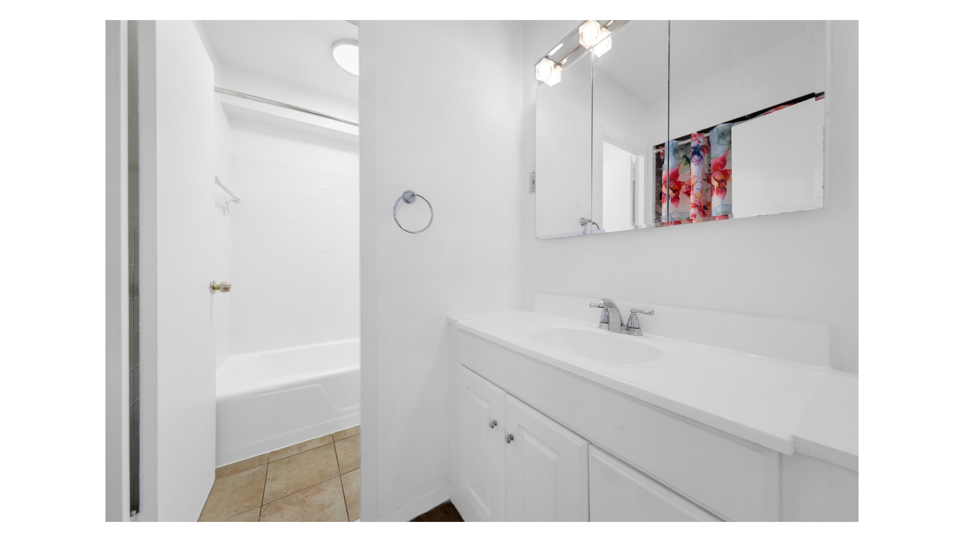 310 West 56th Street, Unit 10F Manhattan, NY 10019 - Photo 5 of 6 a bathroom with a sink a mirror and a shower