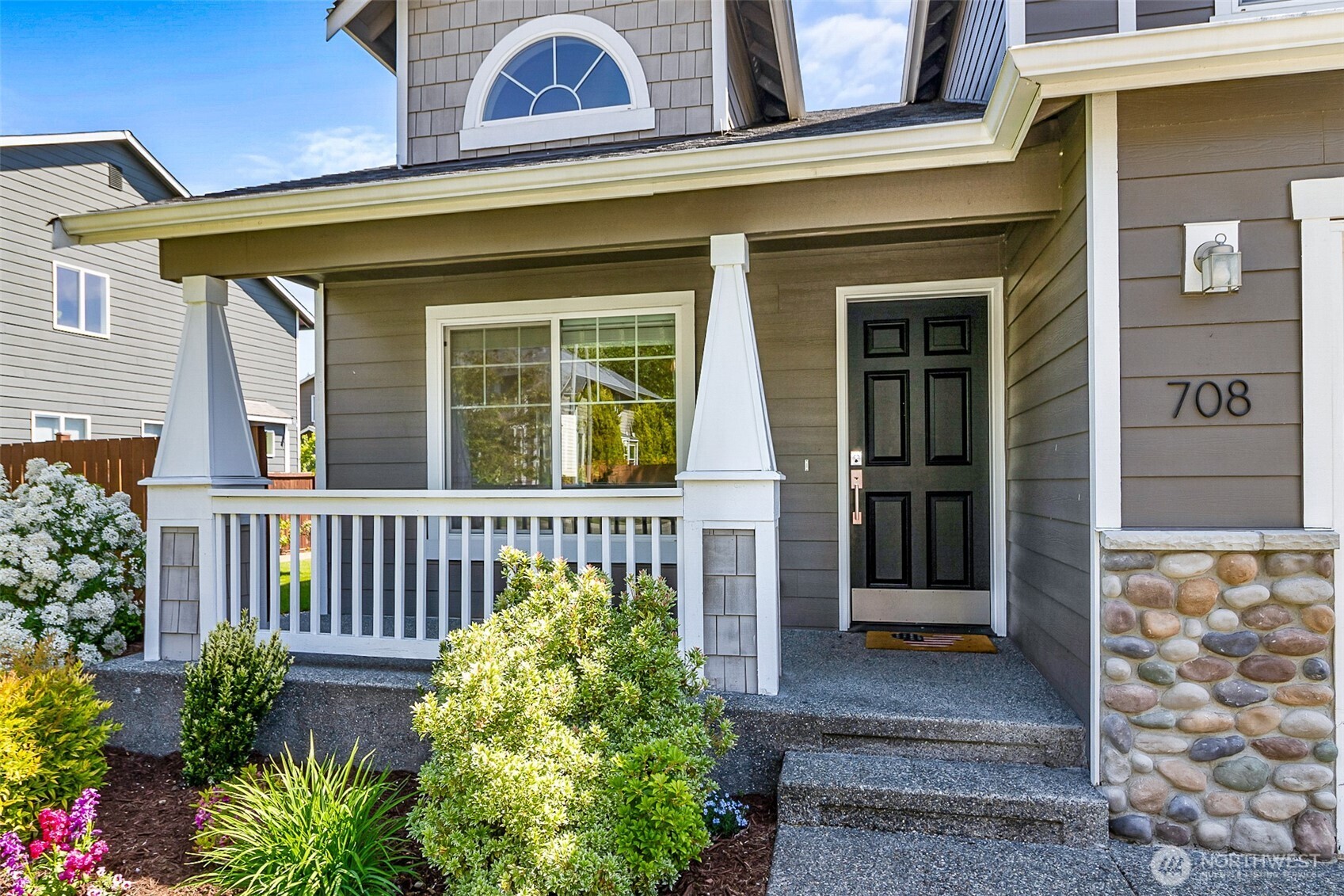 708 Rosario Place Northeast Renton, WA 98059 - Photo 2 of 38 a view of a brick house with plants and large windows