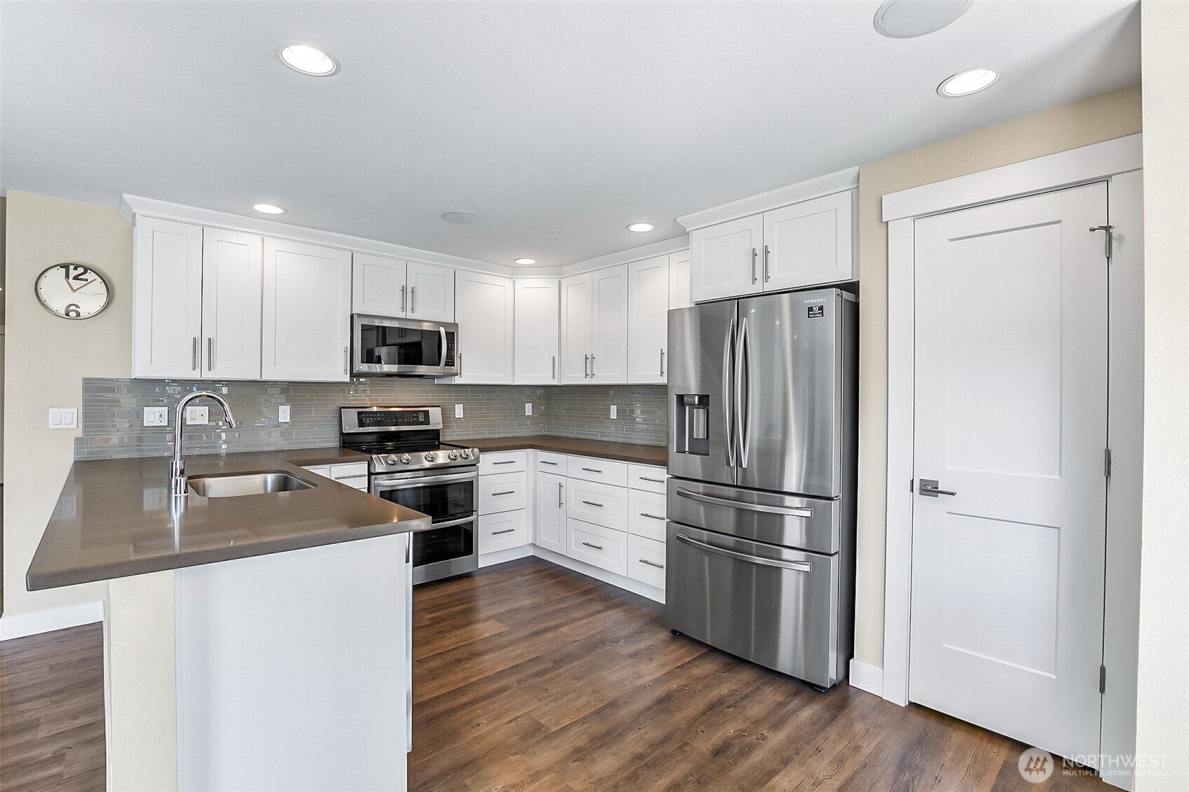 708 Rosario Place Northeast Renton, WA 98059 - Photo 8 of 38 a kitchen with wooden cabinets and stainless steel appliances