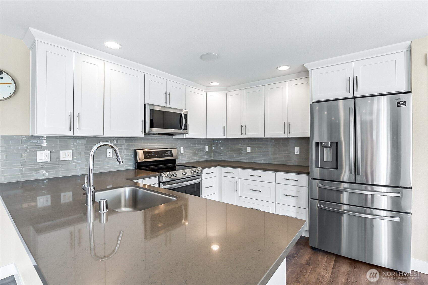 708 Rosario Place Northeast Renton, WA 98059 - Photo 10 of 38 a kitchen with stainless steel appliances granite countertop a refrigerator a stove top oven a sink and cabinets