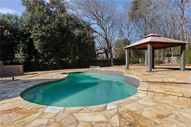 a view of a swimming pool with a patio