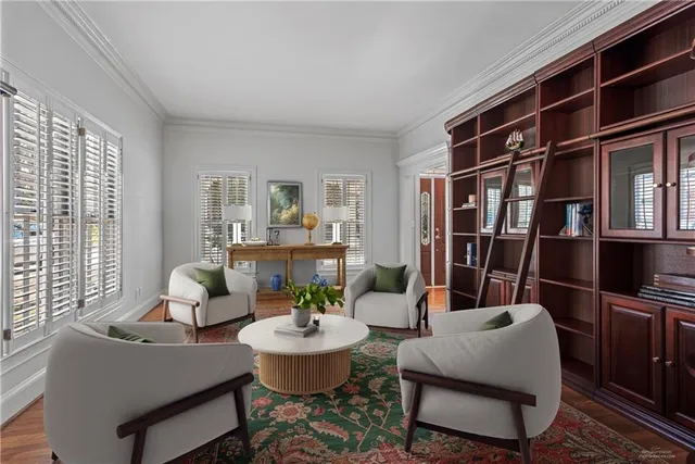 a living room with furniture and a book shelf