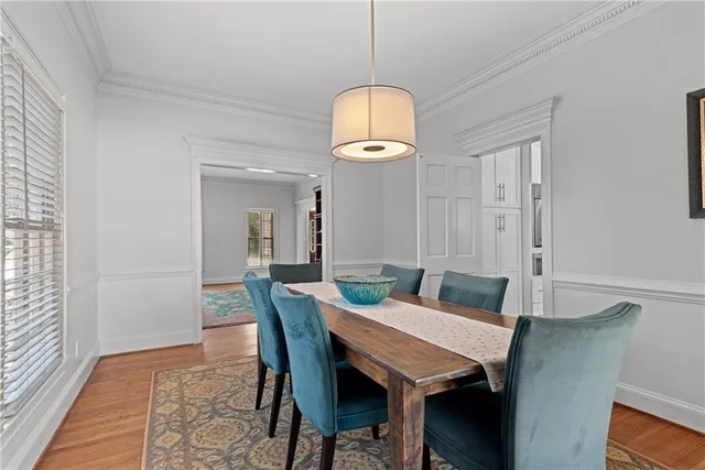 a view of a dining room with a table and chairs