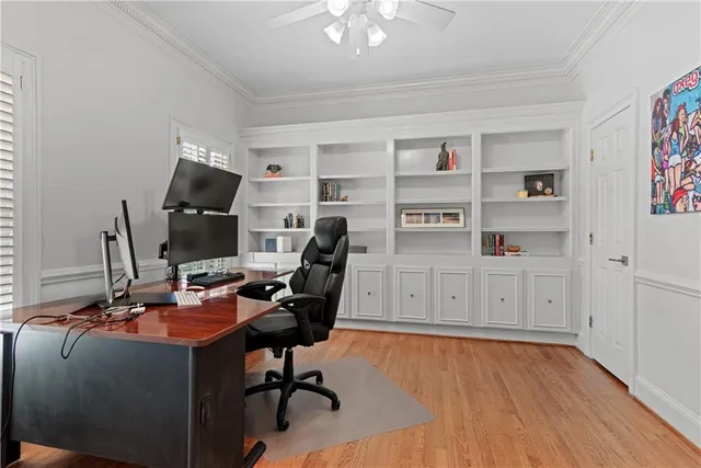 a view of a workspace with furniture and a window