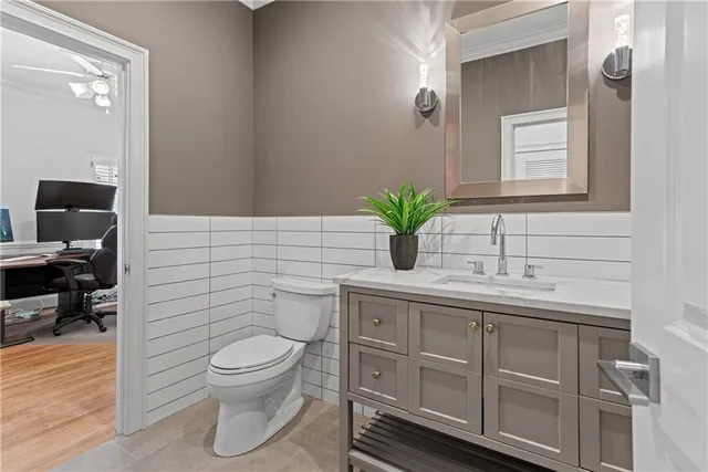 a bathroom with a toilet a sink and mirror