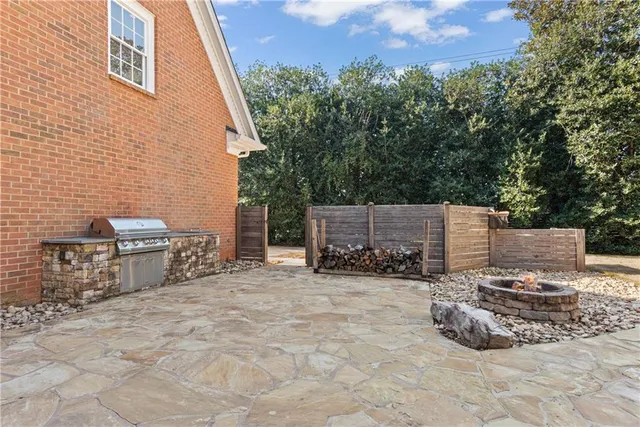 a view of a chairs and table in the back yard of the house
