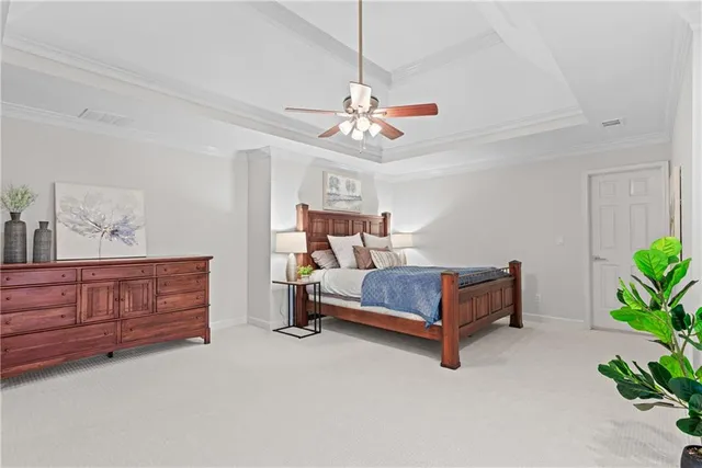 a bedroom with a bed dresser and wooden floor