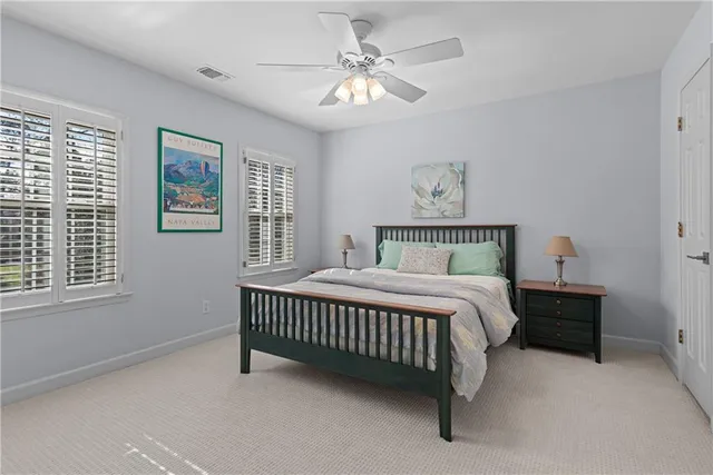 a bed sitting in a bedroom next to a window