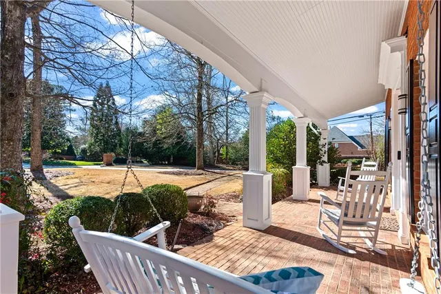 a view of a patio with couches chairs and a yard