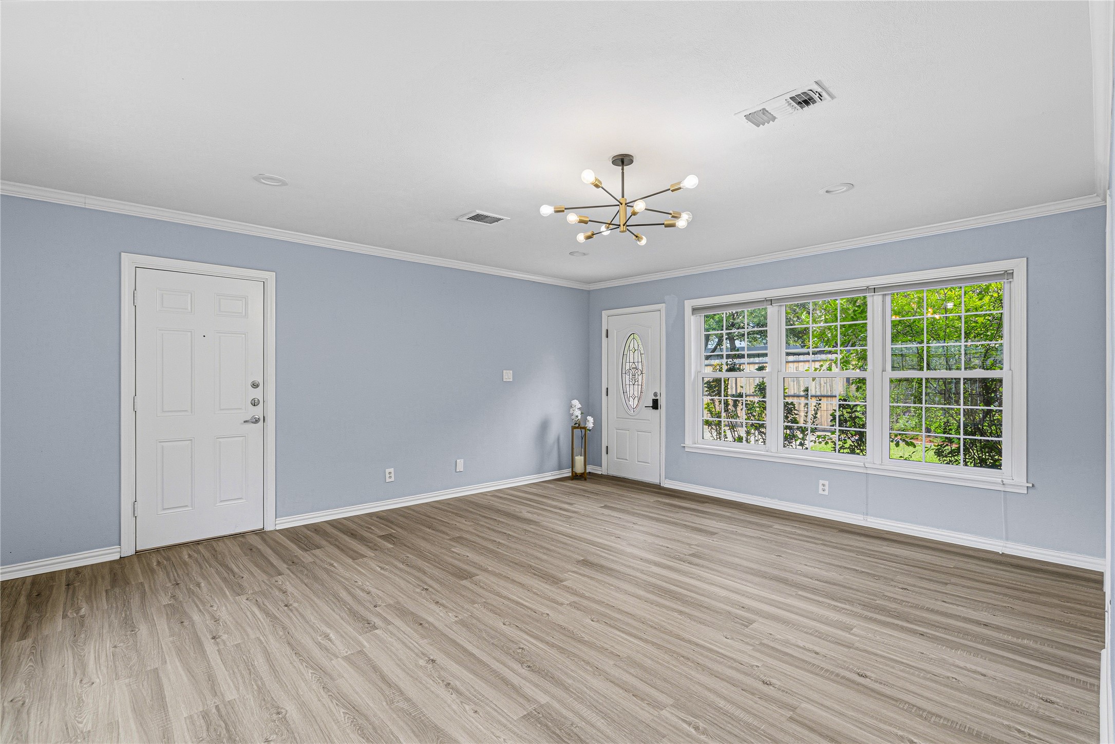 4002 Merrick Street Houston, TX 77025 - Photo 12 of 22 a view of an empty room with a window and wooden floor