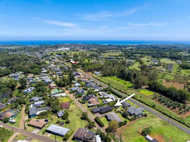 an aerial view of a houses with a swimming pool