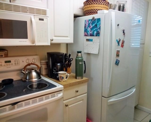 650 West Pope Road, Unit 221 St. Augustine, FL 32080 - Photo 5 of 10 a kitchen with a refrigerator and a stove
