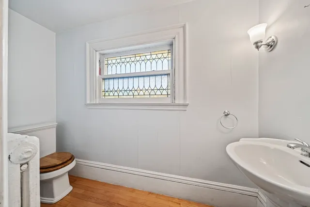 a bathroom with a toilet sink and mirror