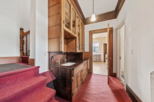 a hallway with a sink and a mirror
