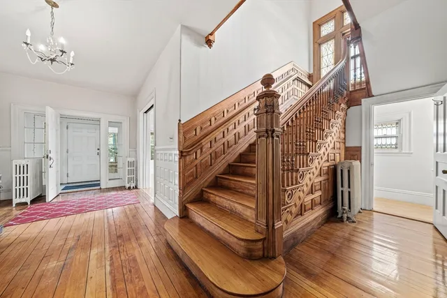 a view of entryway and hall with wooden floor