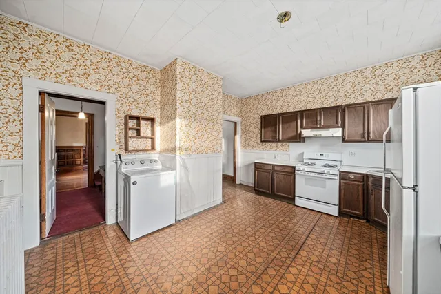 a kitchen with a refrigerator sink and oven