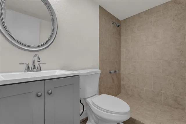 a bathroom with a toilet a sink and mirror