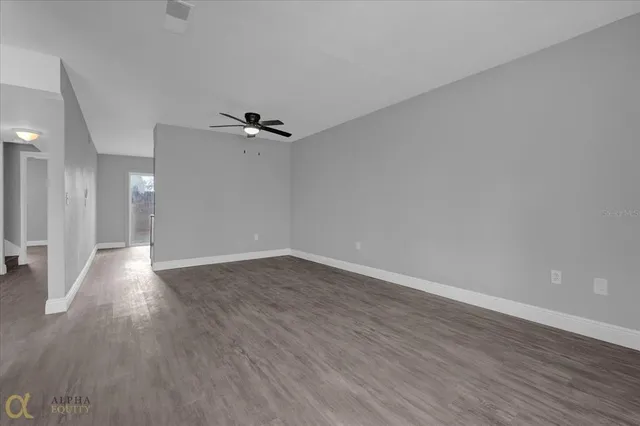 wooden floor in an empty room with a window