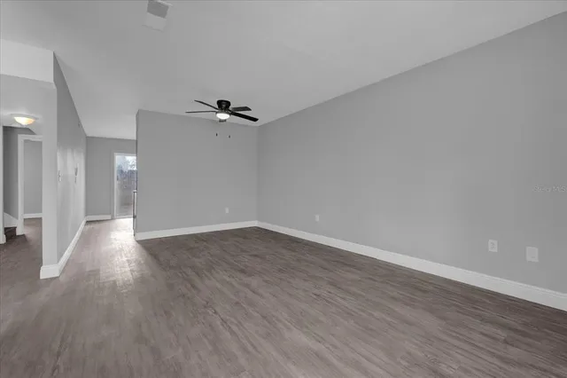 wooden floor in an empty room with a window