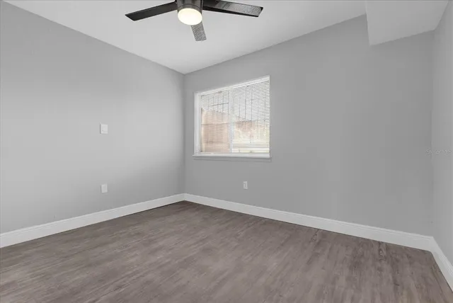 wooden floor in an empty room with a window