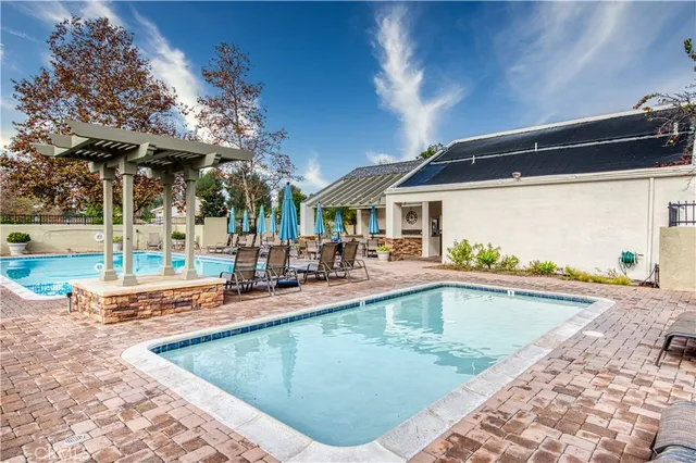 an outdoor space with swimming pool and furniture