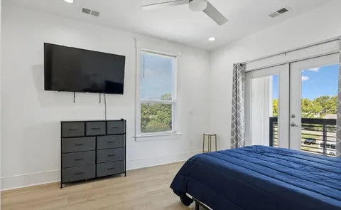 a bedroom with a bed and a flat screen tv