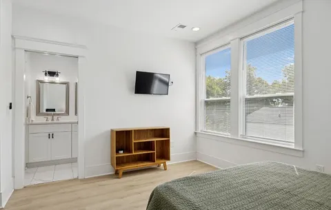 a bedroom with a bed and a flat screen tv