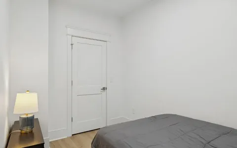 a bedroom with a bed and a lamp