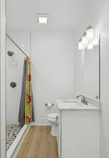 a bathroom with a tub a sink and a shower