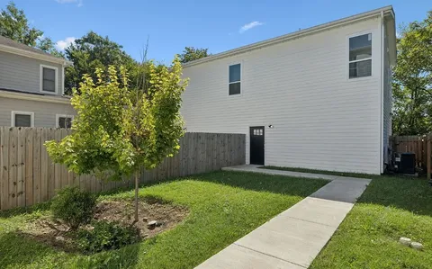 a backyard of a house with plants and trees