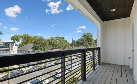 a view of a balcony with wooden floor