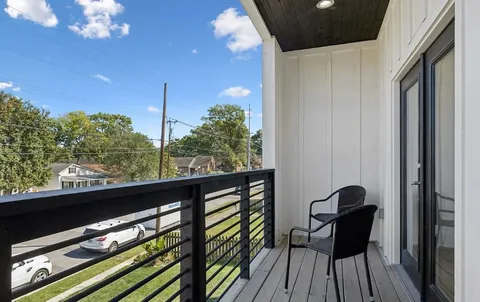a view of balcony with furniture and wooden floor