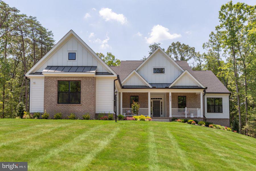 a front view of house with yard and green space