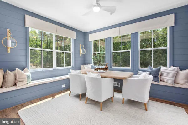 a living room with furniture and large windows