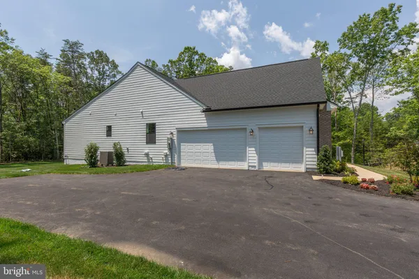 a view of a house with a yard and garage
