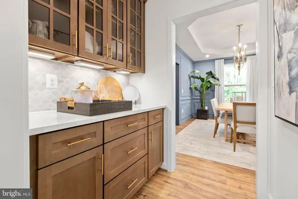 a kitchen with stainless steel appliances granite countertop a table and chairs in it